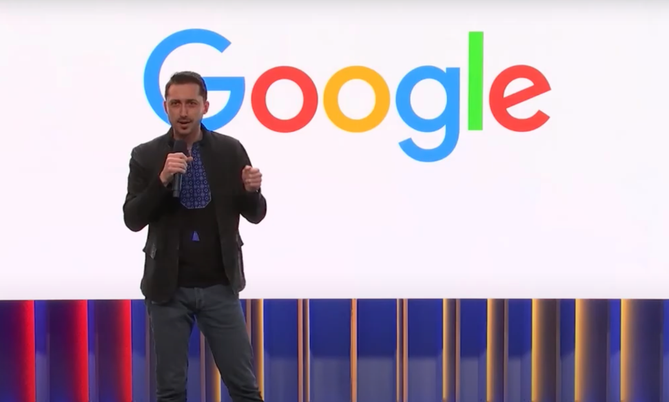 Vitaliy Demyanik speaking on stage at Google